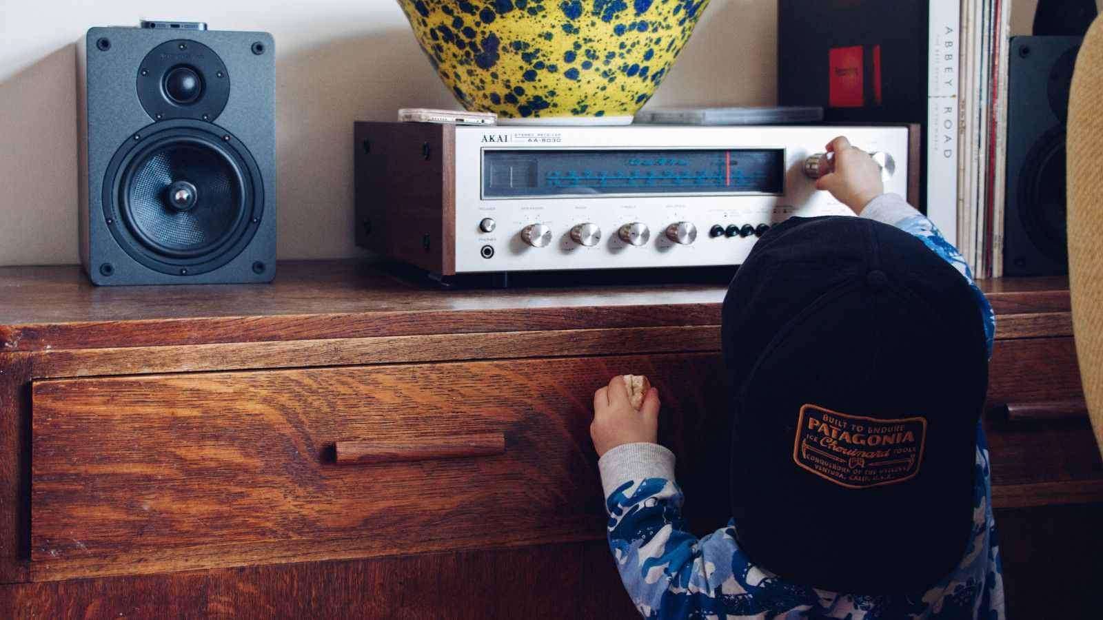 Hand holding electronic device with visible circuitry and components, illustrating the internal mechanisms and lazy evaluation concepts that power Python generators