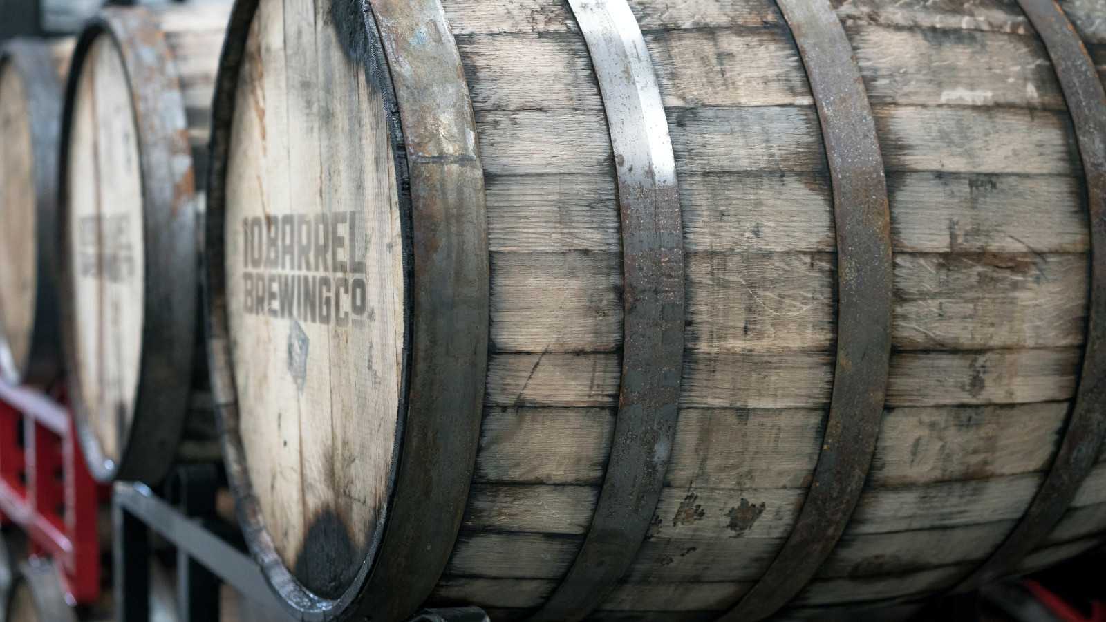 Beige wooden barrel on black crate